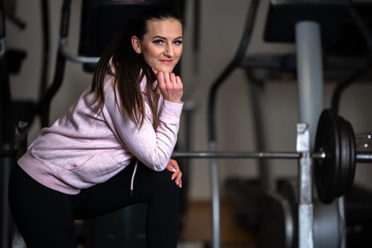 portrait of young beautiful woman fitness instructor in gym.