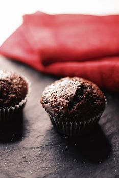 Two chocolate muffins freshly baked at home, homemade comfort food recipe concept