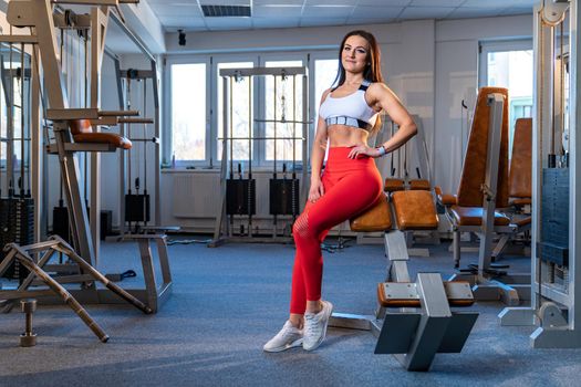 fitness instructor in gym sports beautiful young woman.