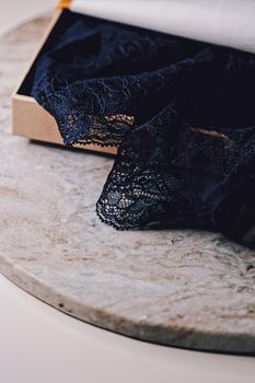 Lace garment inside elegant gift box as luxury purchase, closeup