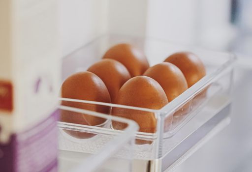 fresh eggs in refrigerator, dairy product closeup