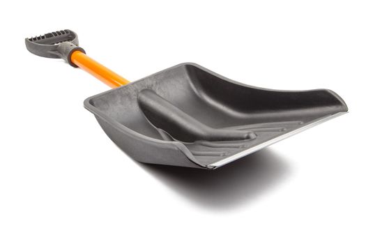 small plastic snow shovel, isolated on white background - back side, laid down, diagonal perspective blade toward camera