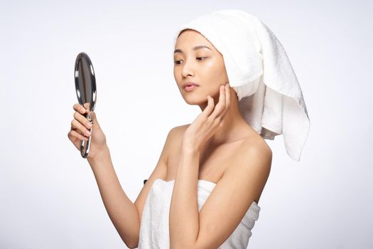 pretty woman looking in the mirror clean skin after shower. High quality photo