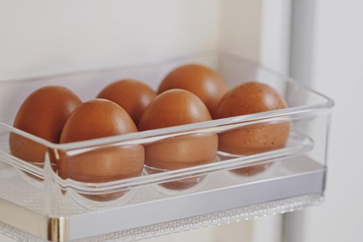 fresh eggs in refrigerator, dairy product closeup