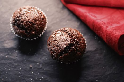 Two chocolate muffins freshly baked at home, homemade comfort food recipe concept