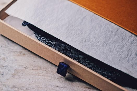 Lace garment inside elegant gift box as luxury purchase, closeup