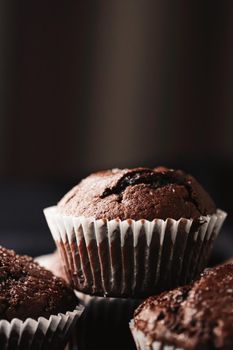 Homemade chocolate muffins, baked comfort food recipe concept