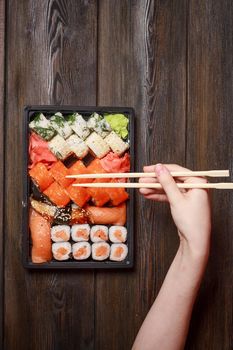 asian cuisine sushi and rolls on the table wooden sticks ginger wasabi. High quality photo
