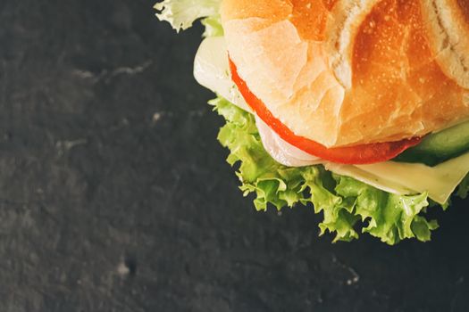 Sandwich with ham, cheese, veggies and lettuce, fast food closeup