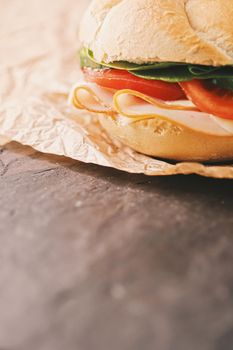 Sandwich with ham, cheese and fresh greens, take out comfort food closeup