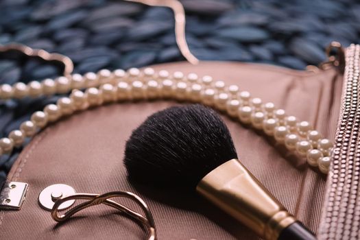 Jewellery and makeup tools inside a womans purse, beauty and fashion closeup