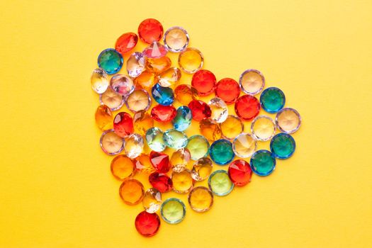 colorful diamond jewelry heart gift holiday yellow background. High quality photo