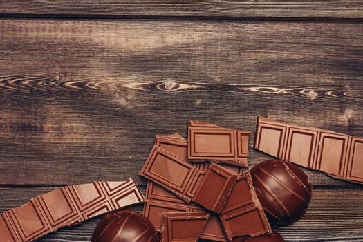 sweets chocolate cakes with icing on wooden background. High quality photo
