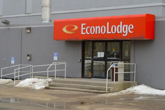 SMITHS FALLS, ONTARIO, CANADA, MARCH 10, 2021: The back entrance to the Econolodge Hotel located along the Rideau Canal in Smiths Falls, ON.