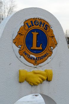 SMITHS FALLS, ONTARIO, CANADA, MARCH 10, 2021: A closeup view of the logo and handshake emblem of the Lions Club Monument made of stone found along the Victoria Park pathway located in small town Smiths Falls.