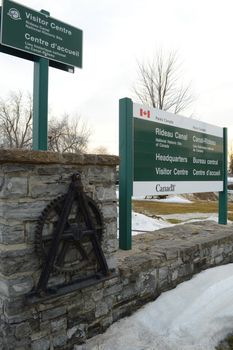 SMITHS FALLS, ONTARIO, CANADA, MARCH 10, 2021: Closeup view of the sign for the Parks Canada Rideau Canal National Historic Site Headquarters Visitor Centre located downtown Smiths Falls, ON, on a late winter afternoon.