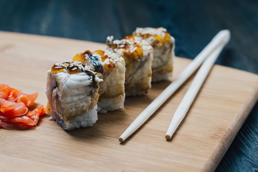sushi chopsticks ginger red on a wooden board snack. High quality photo