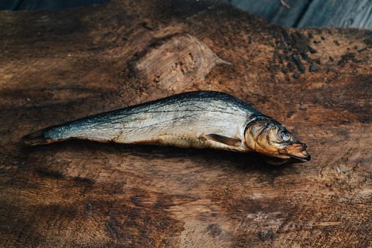 dried fish lies on a wooden table top view texture background image. High quality photo