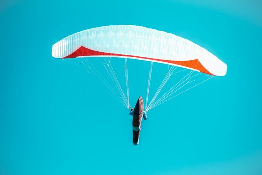 sailing on a paraglider in the blue sky.