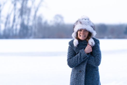 freezing woman on winter icy lake.