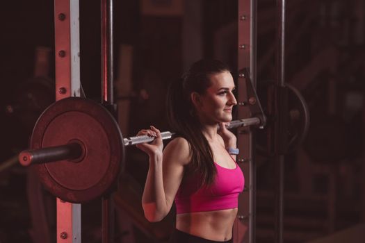 young fitness girl lifts weights in the gym.