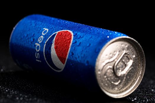 Editorial photo of Pepsi can with water droplets on black background. Studio shot in Bucharest, Romania, 2021