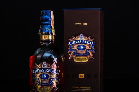 Chivas Regal 18 is blended from whiskies matured for at least 18 years. Whisky bottle on barrel. Illustrative editorial photo Bucharest, Romania, 2021