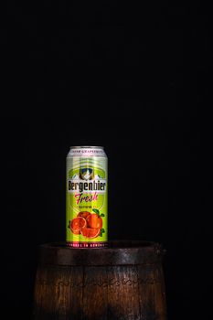 Can of Bergenbier beer on beer barrel with dark background. Illustrative editorial photo Bucharest, Romania, 2021