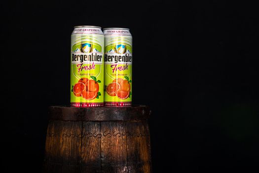 Can of Bergenbier beer on beer barrel with dark background. Illustrative editorial photo Bucharest, Romania, 2021