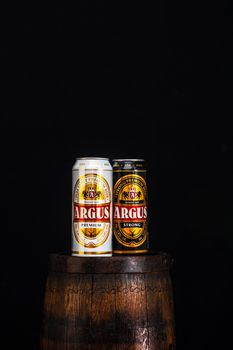 Can of Argus beer on beer barrel with dark background. Illustrative editorial photo Bucharest, Romania, 2021