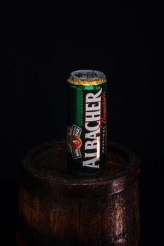 Can of Albacher beer on beer barrel with dark background. Illustrative editorial photo shot in Bucharest, Romania, 2021