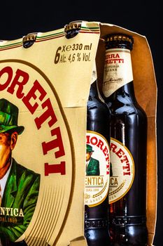 6 pack of Birra Moretti beer on wooden barrel with dark background. Illustrative editorial photo Bucharest, Romania, 2021