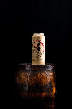 Can of Birra Moretti beer on wooden barrel with dark background. Illustrative editorial photo Bucharest, Romania, 2021