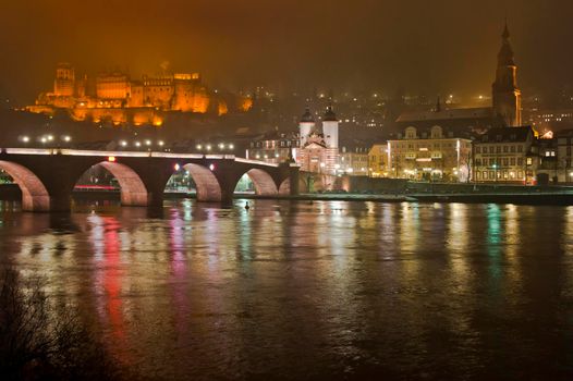 Heidelberg, Snowy night city view by the river Rhein, Karl Theodor Bridge, Germany, Europe