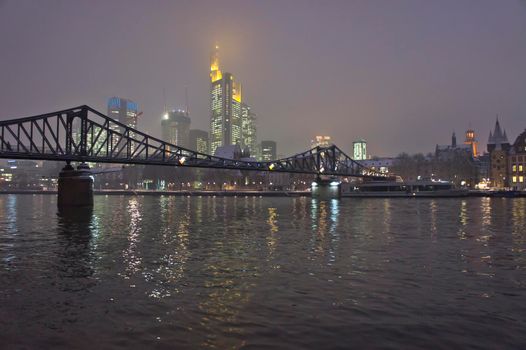 Frankfurt, Snowy night city view by the river Rhein, Germany, Europe