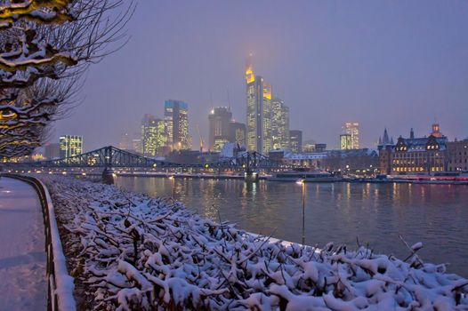 Frankfurt, Snowy night city view by the river Rhein, Germany, Europe