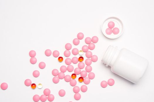 White jar with pills on a light background top view medicine health vitamins. High quality photo