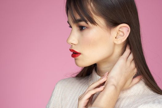 Beautiful brunette red lips white blouse close-up attractive view pink background. High quality photo