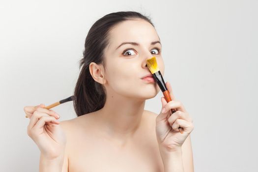brunette bare shoulders face mask brushing cropped view skincare. High quality photo