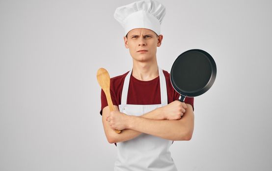 male chef with kitchen utensils cooking food service. High quality photo