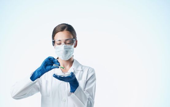 woman doctor in blue gloves and in a medical gown vaccine chemical element laboratory. High quality photo