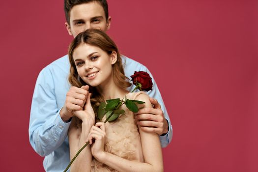 Cheerful man and woman communication rose in the hands of a date friendship. High quality photo