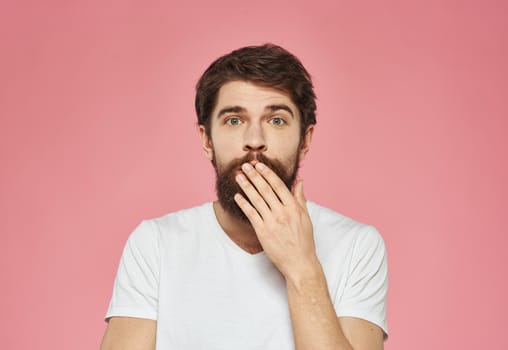 Portrait of a cheerful man on a pink background emotions cropped view. High quality photo