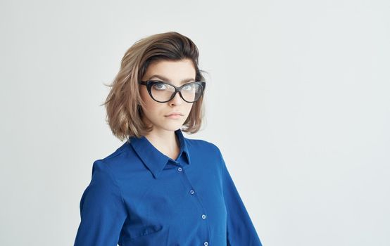 woman in a blue shirt and glasses emotions manager. High quality photo