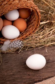 eggs in basket on grey wooden background