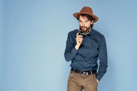 Man in hat emotions joy flowers Studio shirt fashionable clothes. High quality photo