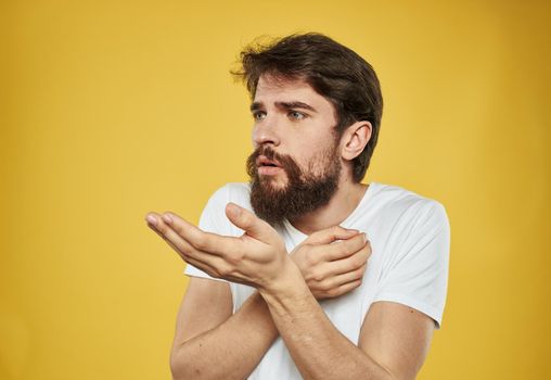 The man has his arms crossed over his chest against a yellow background cropped view. High quality photo
