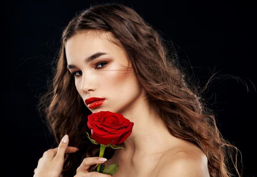 Woman with flower dark background portrait of brunette model. High quality photo