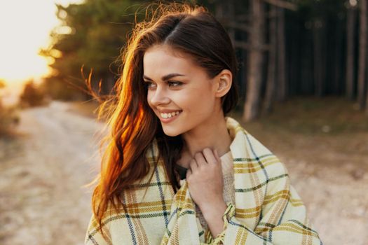 Happy woman trail on shoulders near trees in forest. High quality photo