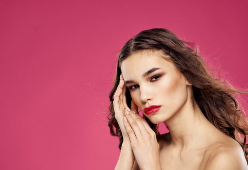 Romantic woman with red lips posing on a pink background. High quality photo